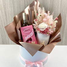 Load image into Gallery viewer, Hat box open hamper with dried &amp; preserved arrangement in pinks and white, 750ml bottle semillon Sav Blanc, 125g Lindt chocolates strawberries &amp; cream 
