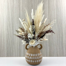 Load image into Gallery viewer, Dried and preserved everlasting arrangement set in a textured handled vase. Flowers consist of pampas, fern, billy buttons, bunny tails, hydrangea, sunflower pod, palm leaf ming fern and other folliage
